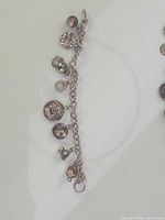 Full view of sterling silver charm bracelet with eight charms