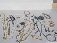 All jewelry pieces spread out on white surface
