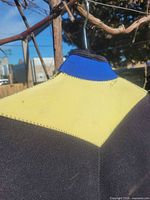 Close view of upper back showing yellow and blue neoprene panels and stitching