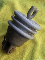 Side view of porcelain insulator showing ribs and top clevis eye