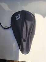 Top view of black gel bike seat cover showing contoured shape and logo