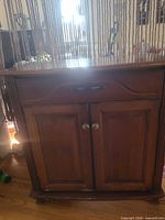 Front view closed showing drawer and double doors