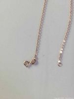 Close-up of clasp and chain links showing rose gold plated sterling silver box chain and spring ring clasp