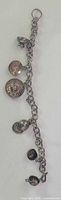 Full view of sterling silver charm bracelet showing chain and attached charms