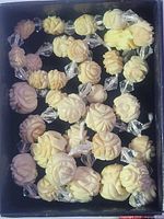 Top view of strung carved bone flower beads with clear spacers