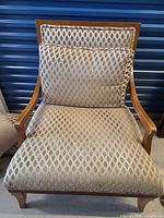 Front view of Bergère chair without toss cushions showing upholstery and wood frame