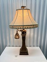 Full view of lit elephant table lamp with shade and pendant nightlight