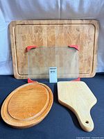 All three wooden boards grouped: large end-grain board, oval board, paddle board