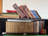 Shelf with large grouping of books, including uniform tan set, German decorative volumes, art texts, miniatures