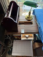 Group view of lamp, magazine rack, record rack, stationery