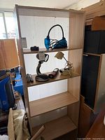 Front view of light laminate bookcase with four shelves