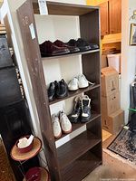 Full front view of brown wood-grain laminate bookshelf with five shelves