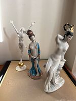 All three porcelain figurines standing together