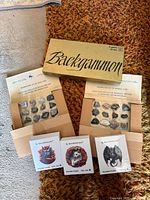 Lot overview showing backgammon box, two mineral trays and three puzzle cartons
