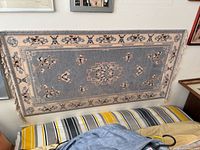 Full view of grey mat mounted on wall above bed