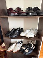 All six pairs of shoes on shelving unit
