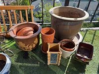 Group of assorted planters on balcony artificial turf