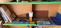 Shelf showing drafting tools, geometry set, precision bits and clamps