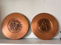 Front view showing both copper plaques and figural designs
