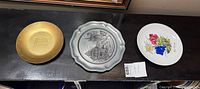 All three plates side by side showing materials and designs