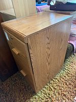 Front and side view of two-drawer oak-look MDF filing cabinet