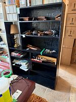 Front view of black wood bookshelf with shelves