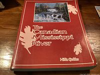 Front cover of red softcover book The Canadian Mississippi River