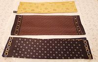 Three ZILLI silk scarves laid flat to show full designs