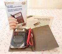 Multimeter, case, leads, manual and box displayed together