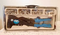 Closed carry case showing rivet tool and rivets through clear lid