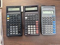 Group shot of three calculators showing fronts and displays