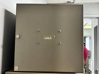 Front view of metal cubby cabinet with closed door