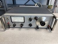Front view showing HP 331A analyzer, analog meter, control knobs, terminals, side handles