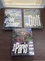 Front view of all three sealed Microsoft software boxes