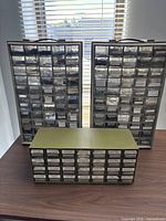 Front view of three drawer cabinets on table