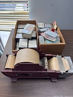 Overall lot showing tape dispenser and two boxes of utility cases