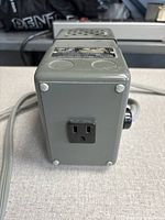 End view showing outlet receptacle and cord