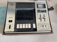 Front/top view showing cassette well, control buttons, meter and sliders