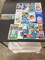 All thirteen Toronto Blue Jays media guides laid out on table, covers visible