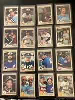 All 16 sleeved 1983 Fleer baseball cards laid out in four-by-four grid