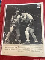 Full view of magazine page in sleeve showing boxing photograph and headline