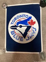 Full view of Toronto Blue Jays velvet poster weighted at corners