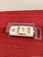 Top view of sealed die-cast Mustang showing number 28 and Red Wings logo