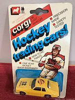Front of sealed package showing yellow Jaguar XJS die-cast car and NHL graphics