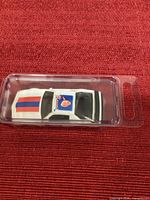 Top view of die-cast Pontiac Firebird showing Braves decal and roof stripes in blister case