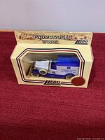 Front view of boxed Lledo promotional model showing 1933 Packard van inside