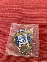 Close-up of sealed 1992 Toronto Blue Jays World Champions lapel pin on red background