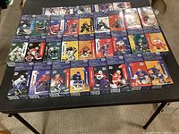 Tabletop view of all 31 sealed Kraft Dinner and Jell-O NHL promotional boxes