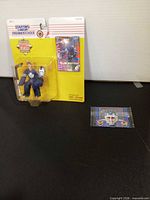 Front view of sealed Starting Lineup package and separate Frosted Flakes card