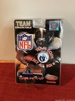 Front of blister pack showing truck, coin, NFL and Broncos graphics